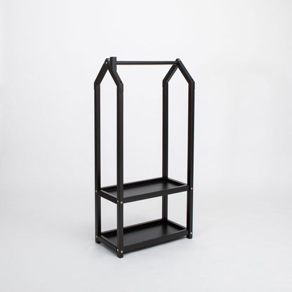 Black metal house-shaped clothing rack with two storage shelves, side view