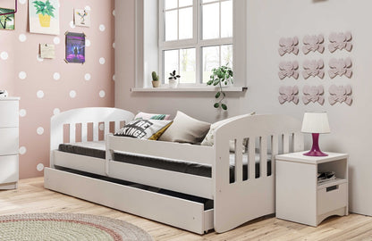 White Kocot Kids Classic 1 children's bed with guardrail in pink bedroom with matching nightstand