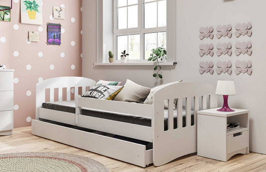 White Kocot Kids Classic 1 children's bed with guardrail in pink bedroom with matching nightstand