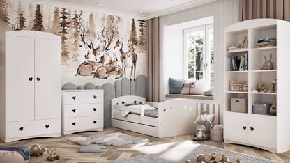 Woodland-themed nursery featuring white Julia bed with heart cutouts and matching storage