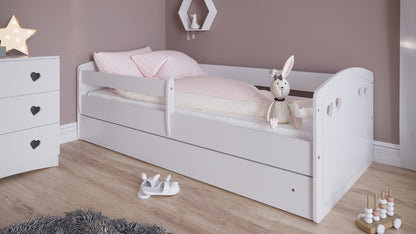 White Julia toddler bed with safety rails and storage drawer, side view with bedding