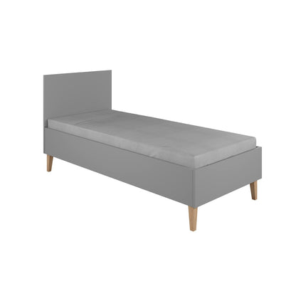 Grey Kubi kids bed angled view displaying headboard, birch slatted base and oak legs