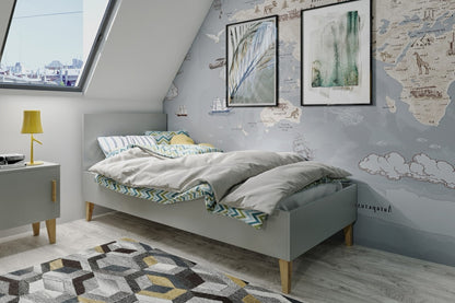 Grey Kubi children's bed with oak legs in Scandinavian bedroom setting with white bedding
