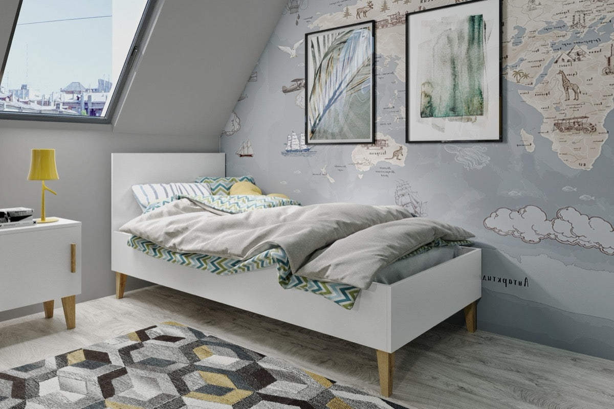 White Kubi children's bed with gray bedding in attic kids bedroom