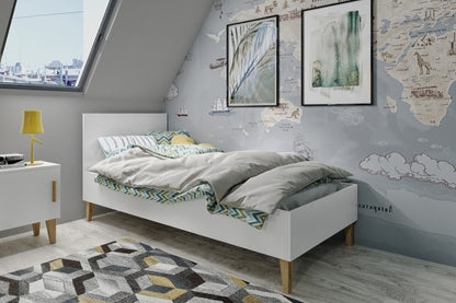 White Kubi children's bed with gray bedding in attic kids bedroom