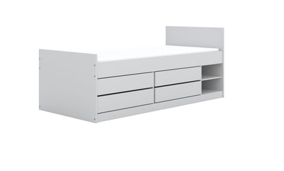 Angled perspective of white kids bed displaying four storage drawers and integrated shelf units