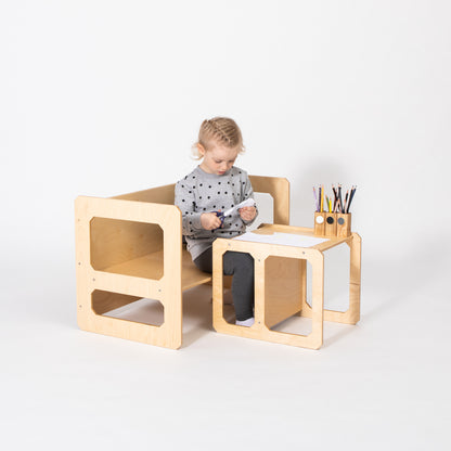 Toddler at natural birch Montessori table with single chair for independent eating