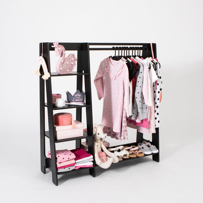 Black kids clothing rack displaying dresses, toys, and shoes with open shelving