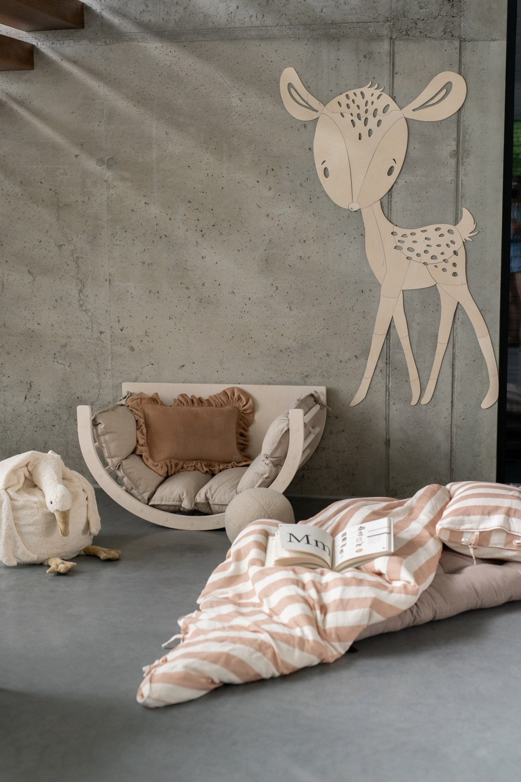 Wooden forest animal deer wall hanging mounted on concrete nursery wall