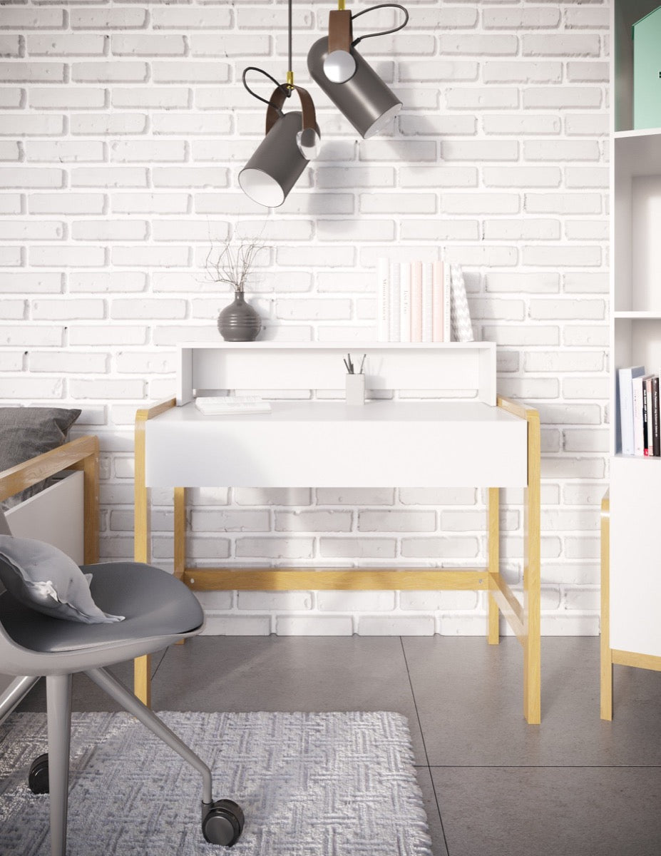 White Scandinavian kids desk with oak legs in modern bedroom workspace with pendant lights and shelving