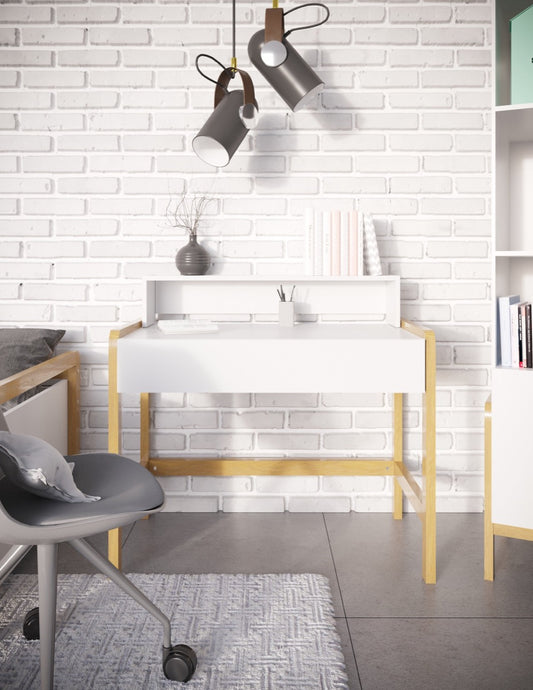 White Scandinavian kids desk with oak legs in modern bedroom workspace with pendant lights and shelving
