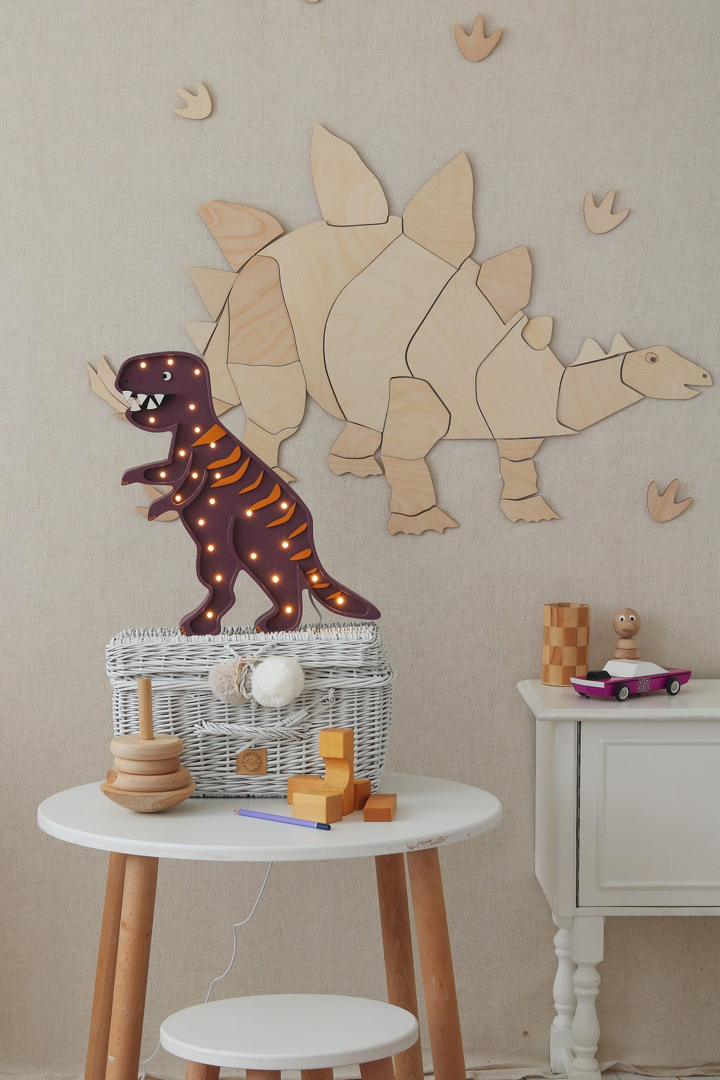 Wooden stegosaurus wall decoration with LED-lit brown dinosaur figurine and toys