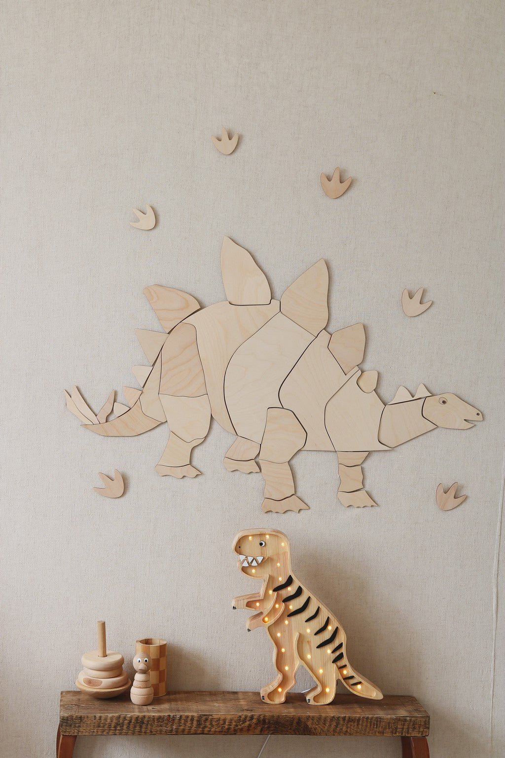 Complete wooden stegosaurus puzzle wall decor with footprints and wooden toy dino display