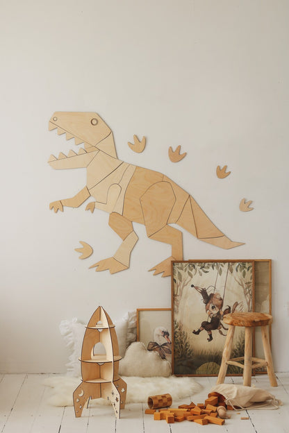 Wooden T-Rex wall decoration assembled with 27 plywood pieces and bonus footprints, displayed in playroom setting