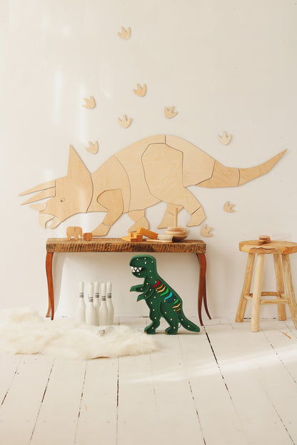 Natural wood triceratops puzzle wall decoration with included footprints and dinosaur toy accessories below