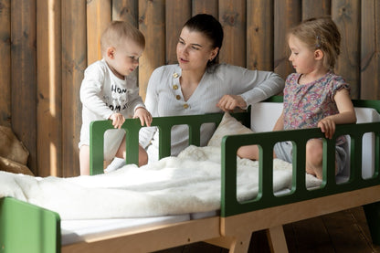 Mother and children playing on green Family-scl growing bed – kids bed for toddlers and older children
