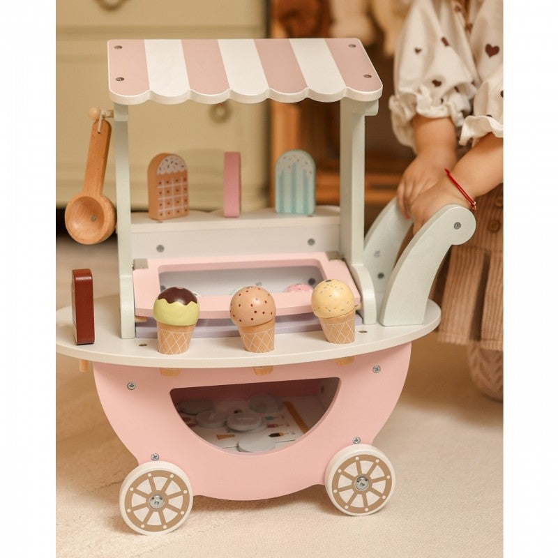 Wooden ice cream cart in bedroom setting with girl engaging in pretend play