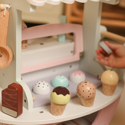 Interior view of wooden ice cream cart showing display shelves with colorful scoops