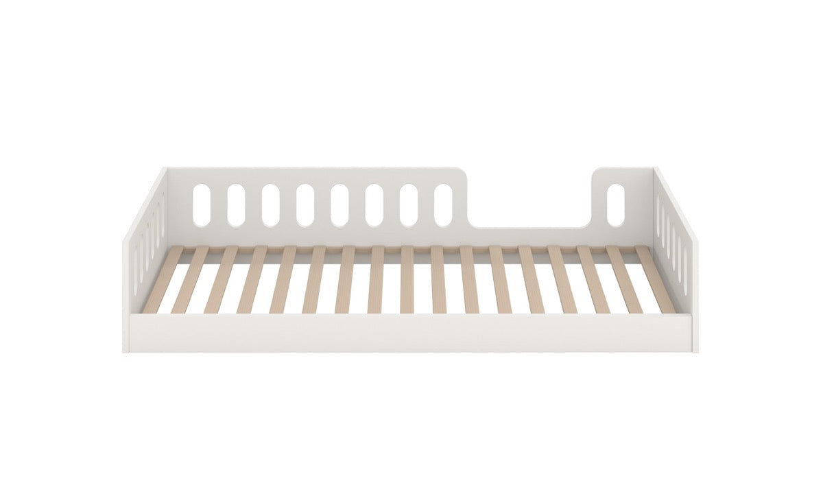 White kids bed with wooden slat base and protective side rails