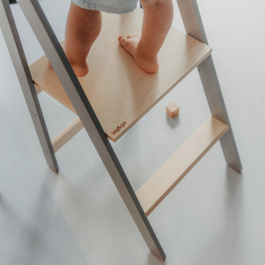 Black and natural wood kitchen tower in angled view with safety rails showing compact design when folded