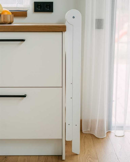 White kitchen tower standing closed in kitchen corner showing tall narrow profile with removable rails inside