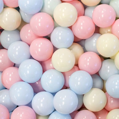 Overhead view of 500 pastel-colored soft play balls in pink, blue, cream, and white tones clustered together