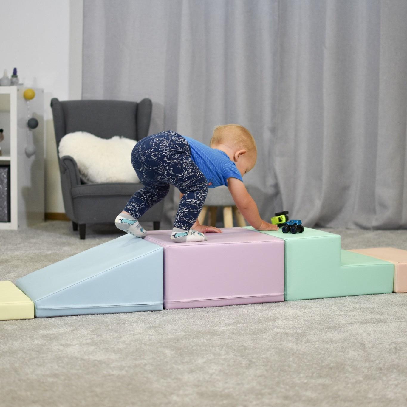 Child balancing on connected foam blocks in various pastel colors