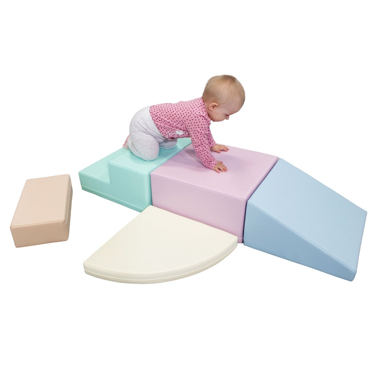 Toddler crawling across corner climber foam block set with soft pastel hues