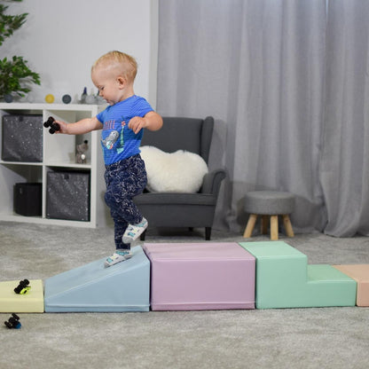 Toddler jumping on pastel foam block set showing balance development