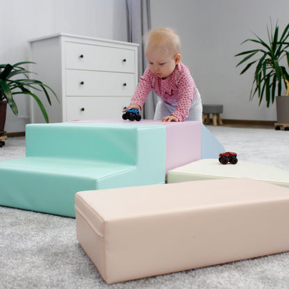 Toddler climbing over light pastel corner climber foam block set