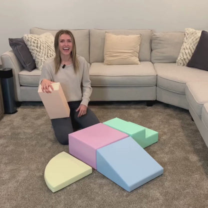 Toddler jumping on blue-gray pastel foam block showing non-slip surface