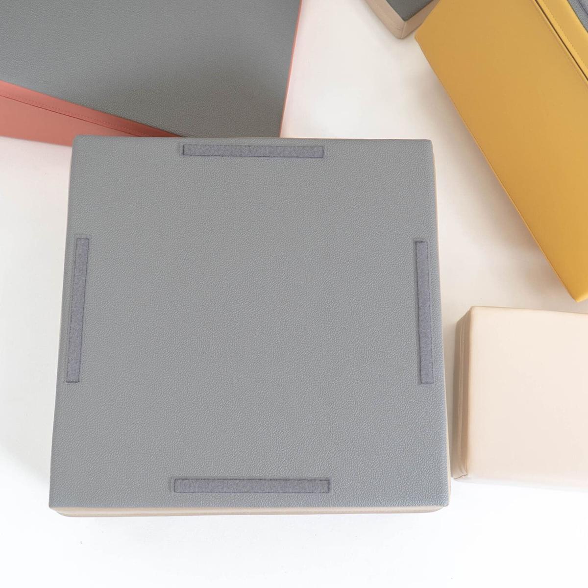 Top view of gray foam block showing fabric handles and non-skid bottom surface
