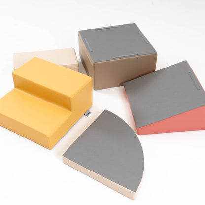 Five individual foam blocks displayed separately showing yellow steps, gray, beige, and pink pieces