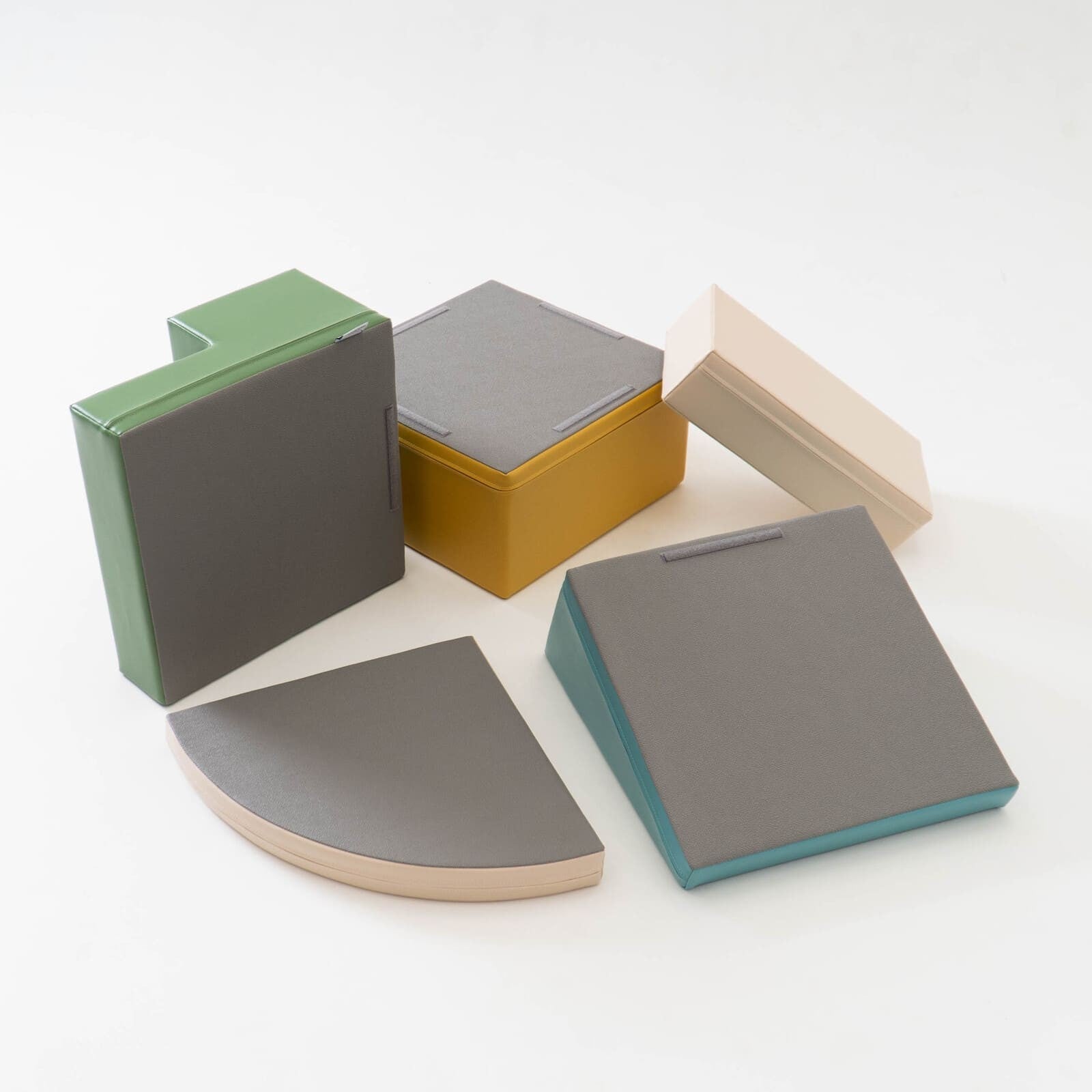 Individual foam blocks for IGLU corner climber set stacked and arranged in various configurations