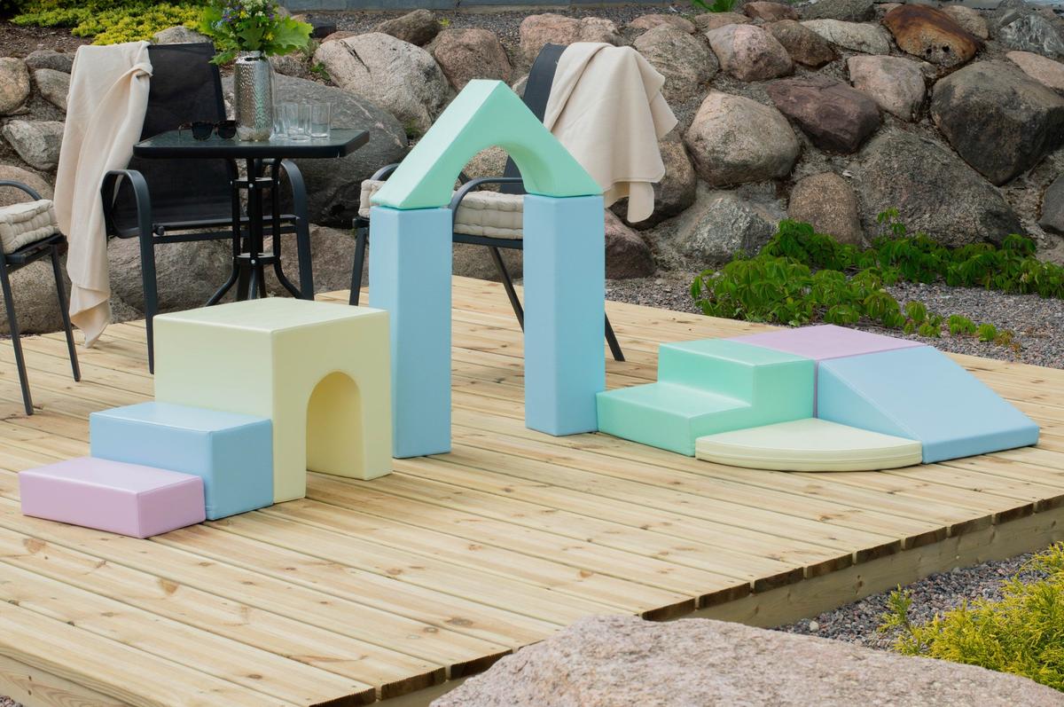 IGLU 10-piece foam block set assembled as house structure on outdoor wooden deck
