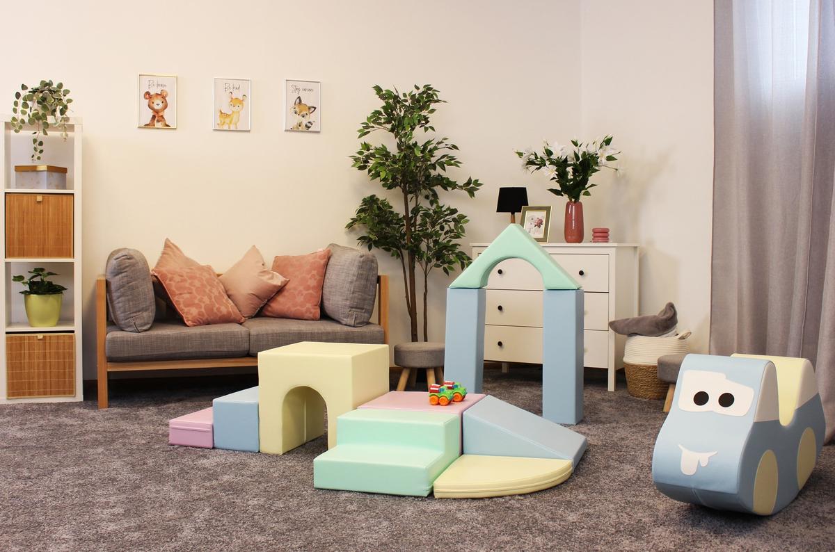 Child's playroom with IGLU foam blocks arranged as structures near sofa and storage