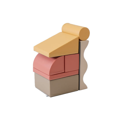 Pastel pink and beige foam blocks stacked vertically with cylinder and wedge foam shapes