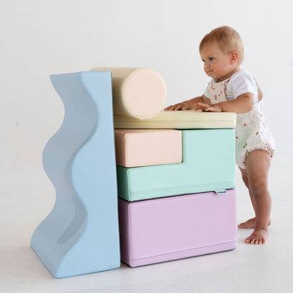 Two toddlers playing on light pastel foam block and ramp structure
