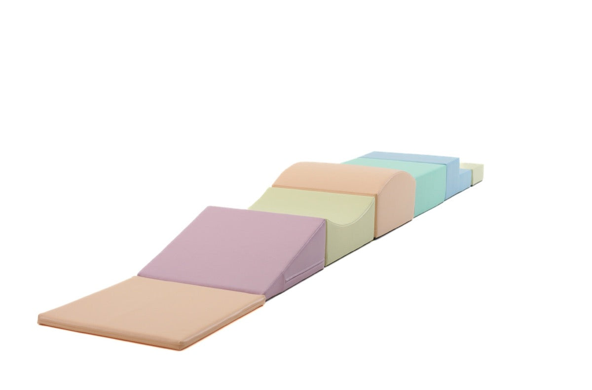 Side view of seven pastel foam blocks in angled stepping configuration
