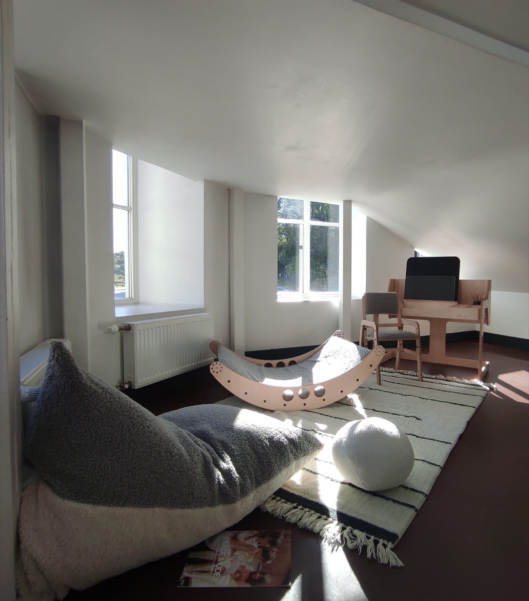 Spacious playroom with cream and gray sherpa bean bag and seating