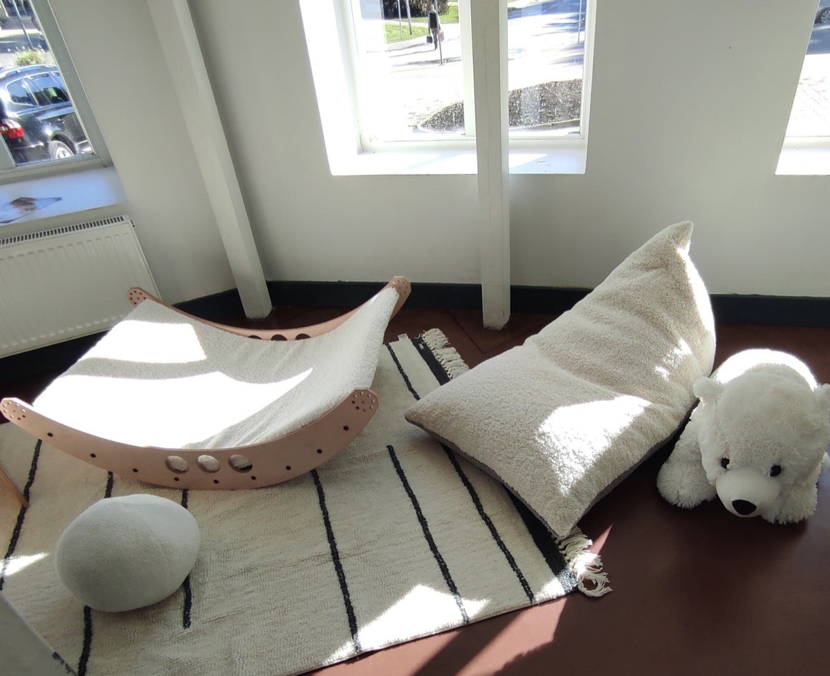 Playroom setup displaying cream and gray sherpa bean bag with toys