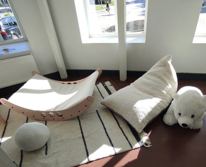 Playroom setup displaying cream and gray sherpa bean bag with toys