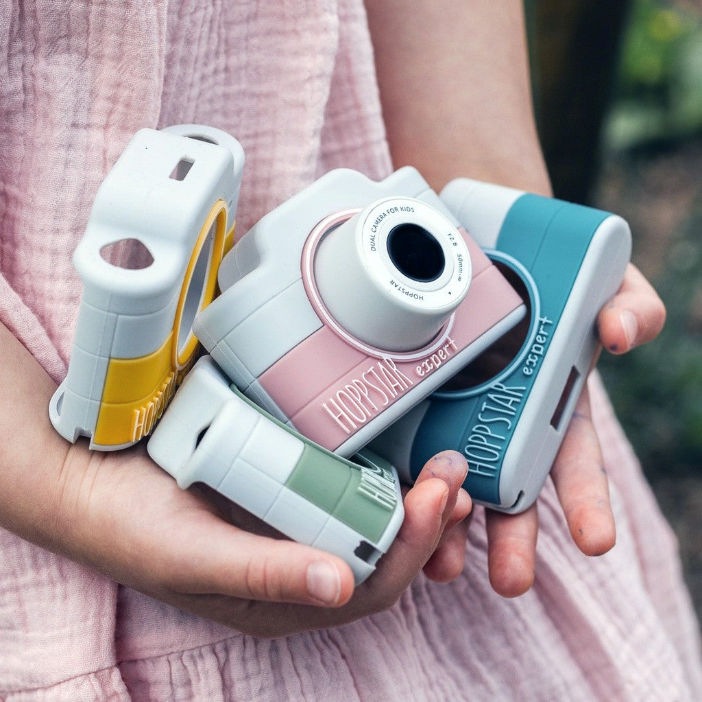 Child holding Hoppstar Expert cameras in all four colours