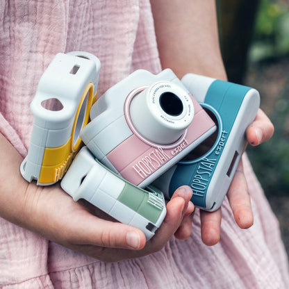 Child holding Hoppstar Expert cameras in all four colours