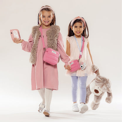 Two girls in pink with the Hoppstar Expert Blush camera and a pink bag
