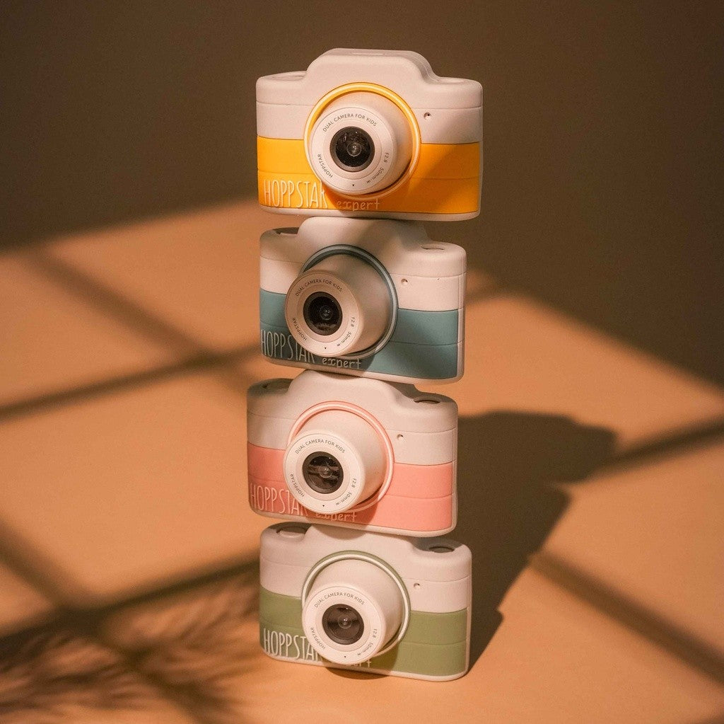 Stack of Hoppstar Expert cameras in Citron, Yale, Blush and Laurel