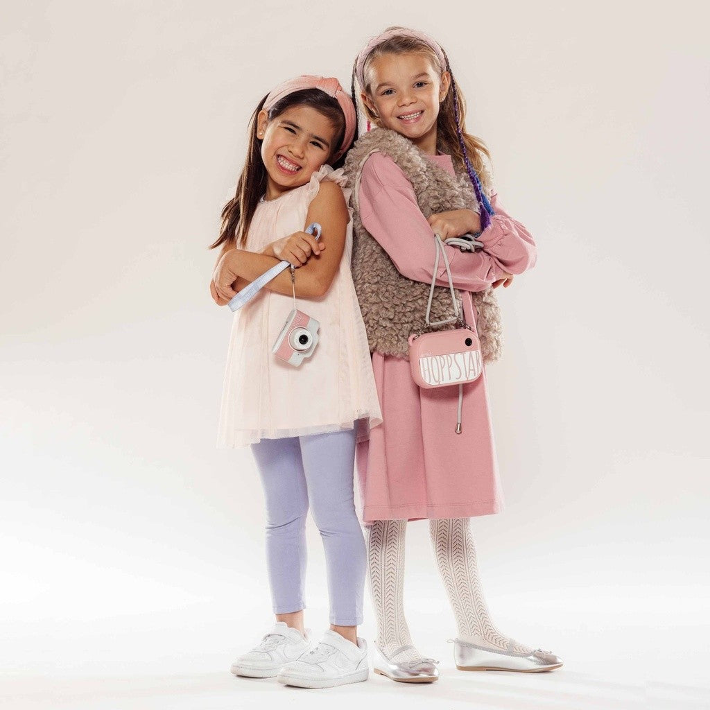 Sisters posing with the Hoppstar Expert Blush kids camera