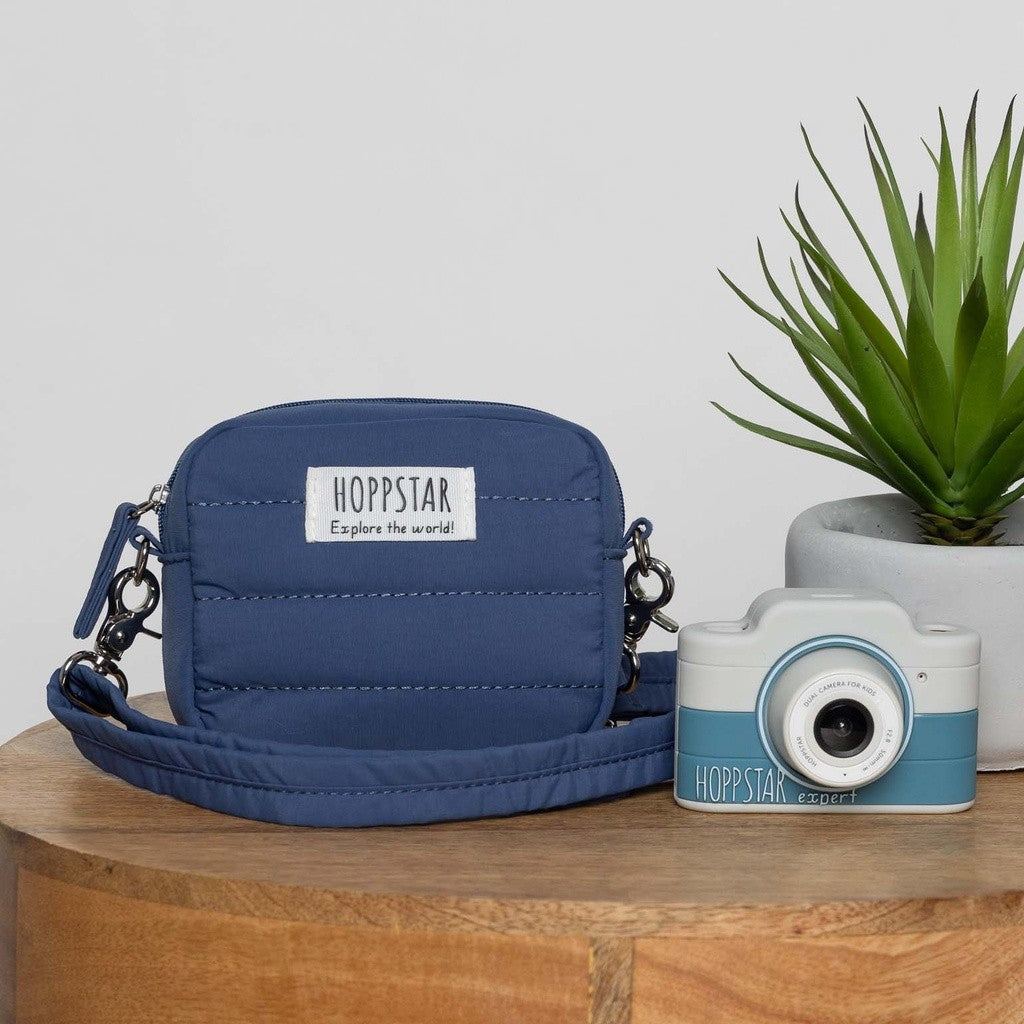 Hoppstar Expert Yale camera next to a navy Hoppstar camera bag