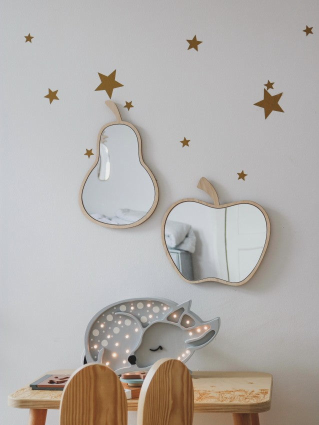 Pear-shaped wooden mirror with natural plywood frame and acrylic reflecting on white wall