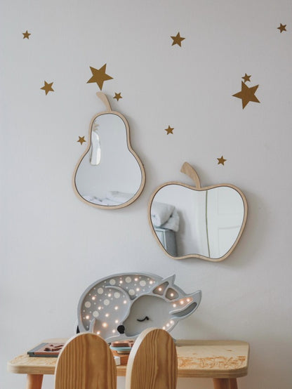 Pear-shaped wooden mirror with natural plywood frame and acrylic reflecting on white wall